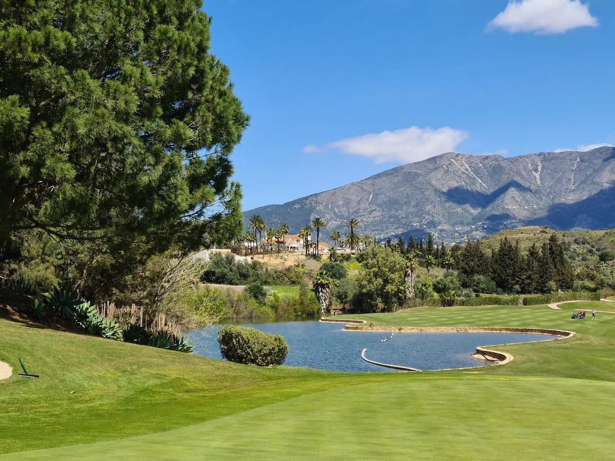 Water hazard with mountain backdrop vista